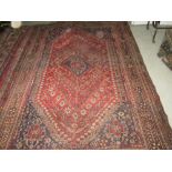 Semi antique wool rug with central lozenge and abstract crab figures 300 cms x 210 cms