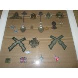 Various regimental cap and pin badge mounted as a display including German medal (Militaria