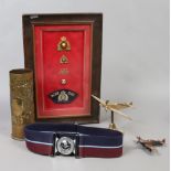 A collection of military related items to include framed badges, Royal Air Force dress belt,