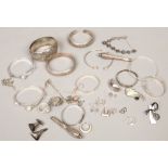 A box of silver and white metal jewellery, some damaged, mainly bangles. Gross weight 204 grams.