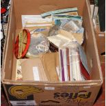 A box lot of loose stamps, postcards and postal ephemera along with a globe masters stamp album