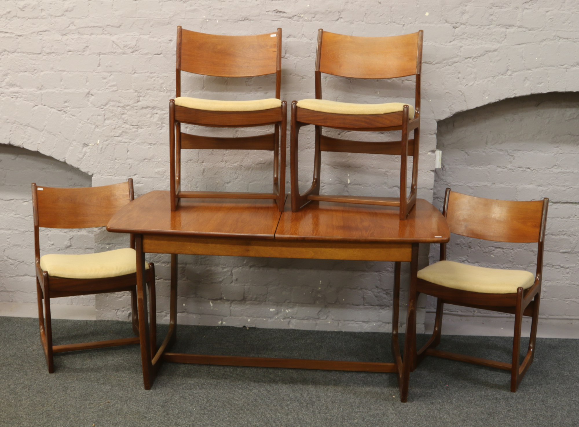 A G plan style teak extending dining table, 181 x 88cm along with four matching dining chairs.
