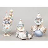 Three Lladro figures of young clowns.