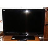 A Samsung flatscreen 32 inch television model number LE32B530P7NXXU remote and power cable.