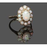 A 9ct gold opal cluster ring assayed London 1976, size O.Condition report intended as a guide only.