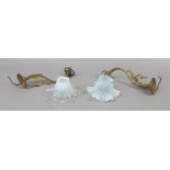A pair of French brass wall sconces with vaseline glass shades.