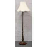 A carved mahogany standard lamp with reeded column.