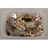 A box of assorted vintage costume jewellery oddments.
