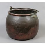 A large copper cauldron with swing handle diameter approximately 43cm.
