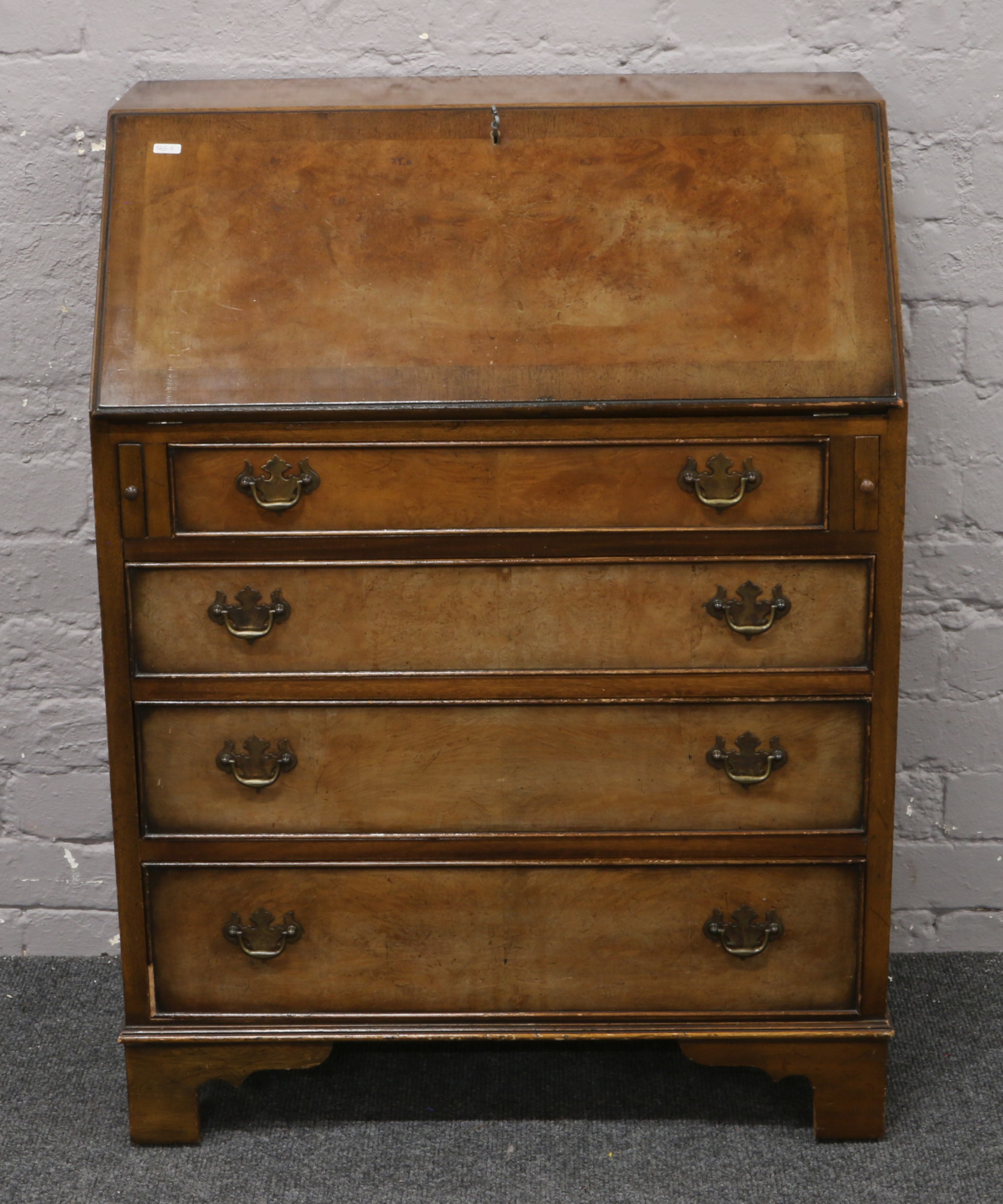 A burr walnut bureau crossbanded in mahogany with fitted interior, raised on bracket feet, 74cm