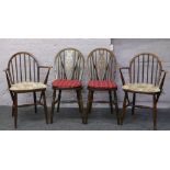 A pair of Ercol spindle back arm chairs, along with a pair of wheel back dining chairs.