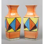 A pair of Clarice Cliff style square baluster vases decorated with geometric patterns, height 29.