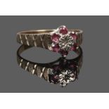 A 9ct gold ruby and diamond daisy cluster ring with cross hatched shoudlers, size S1/2.