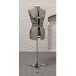 A dressmakers adjustable mannequin with stand.