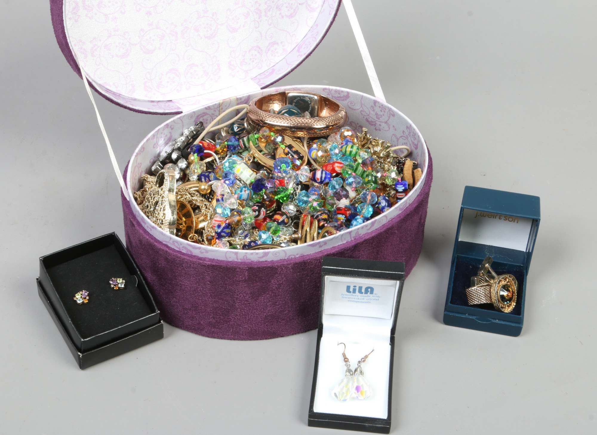 A jewellery box and contents of costume jewellery to include beads, earrings, yellow metal rings,