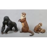 Three country artist composite figures to include large gorilla height 30cm large otter height