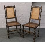 A pair of carved bergere seat and back barleytwist chairs.
