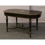 A Victorian ebonised brass inlaid library table raised on reeded tapering supports and with x