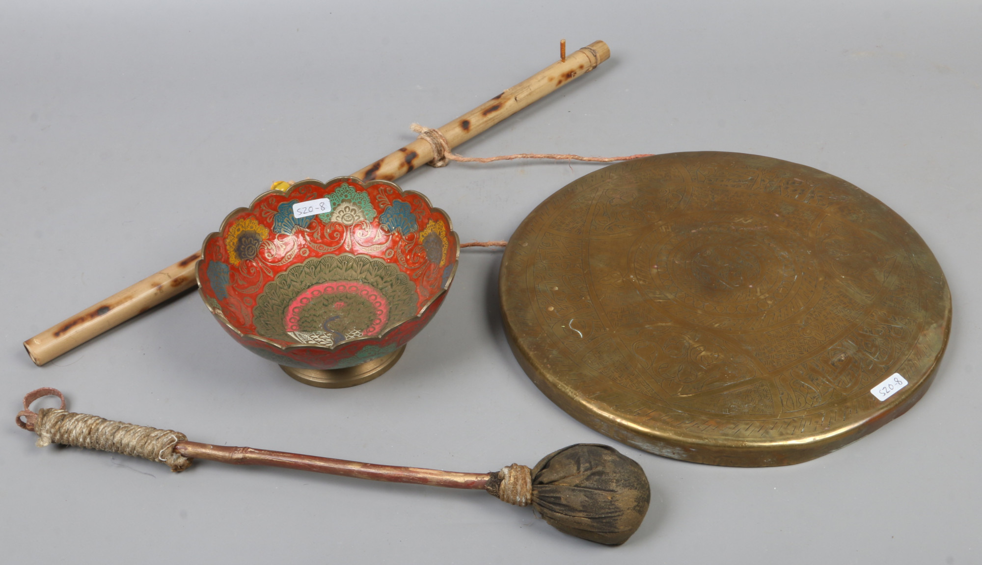 An Indian brass prayer gong along with an Indian brass peacock bowl.