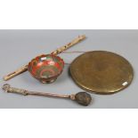 An Indian brass prayer gong along with an Indian brass peacock bowl.