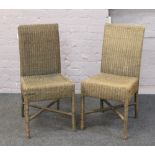 A pair of basket ware chairs.