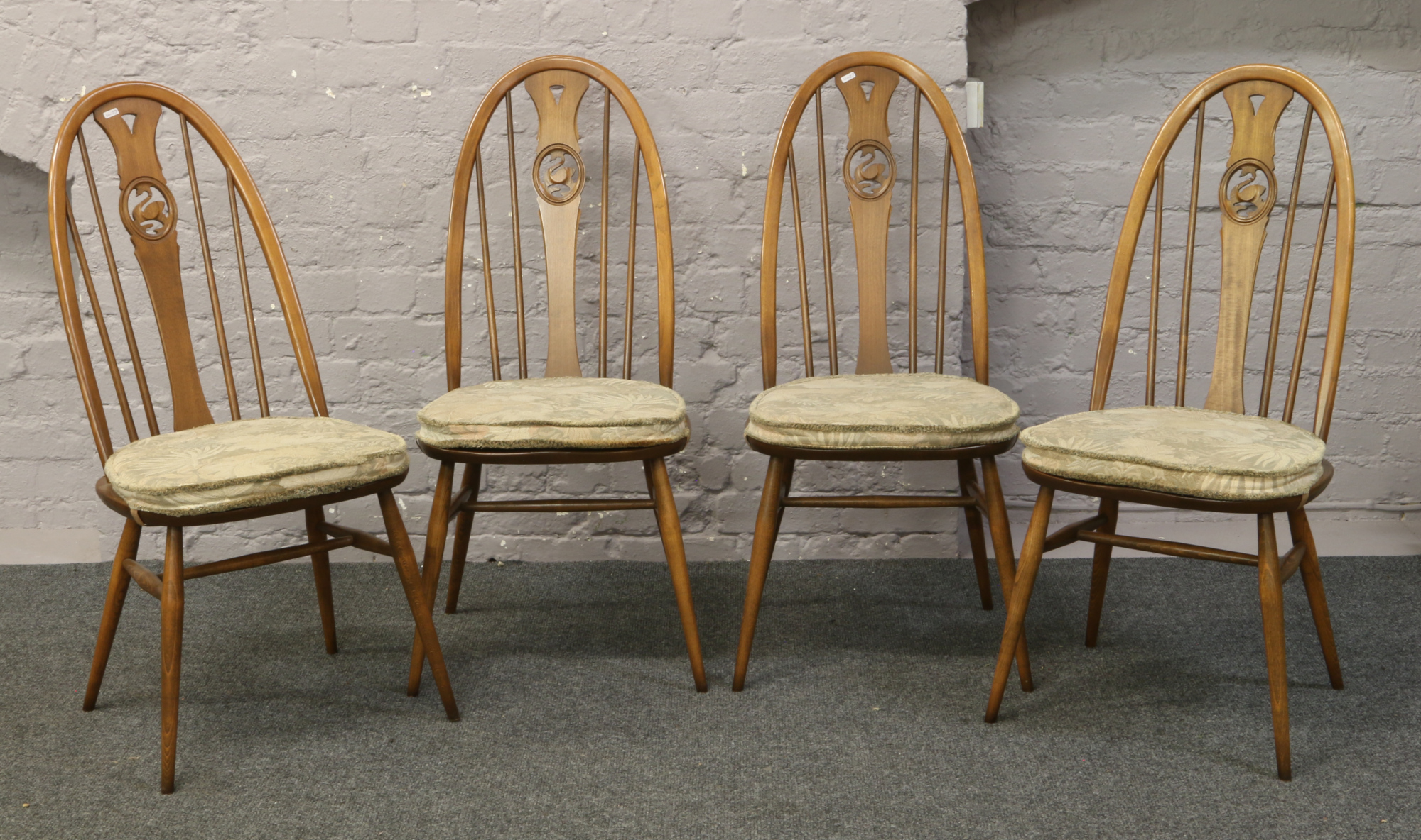 A set of four Ercol Golden Dawn Quaker swan back dining chairs.Condition report intended as a
