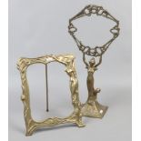 A brass Art Nouveau style figural mirror frame, along with a brass Art Nouveau style easel picture
