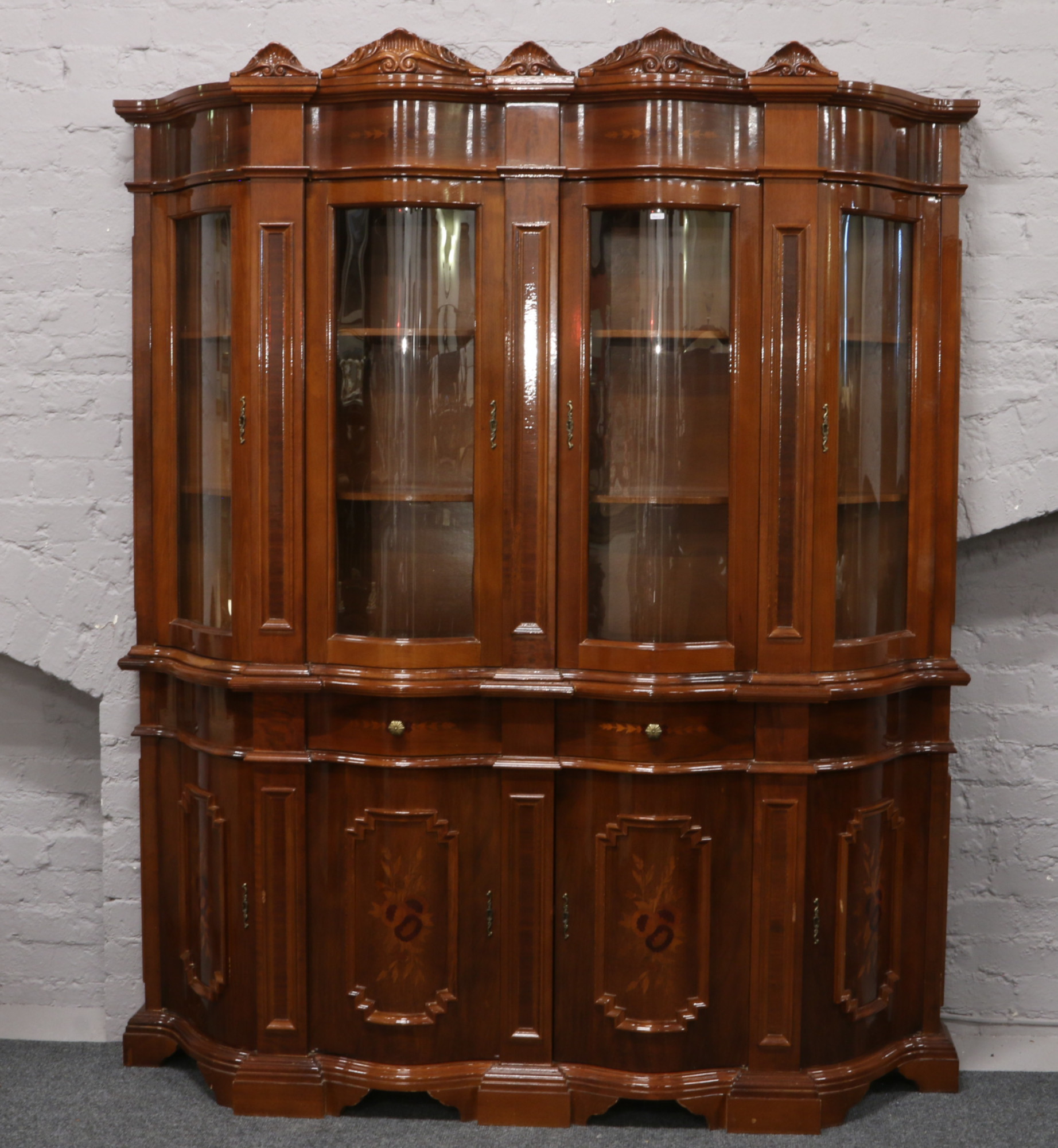 An Italian inlaid mahogany bow front display cabinet.