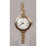 A 9ct gold cased bracelet watch (bracelet gold plated) with enamel dial having Roman numeral