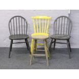 Three painted kitchen chairs and a stool.