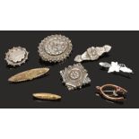 Eight sweetheart brooches including gold and silver examples, wishbone brooch set with a ruby and