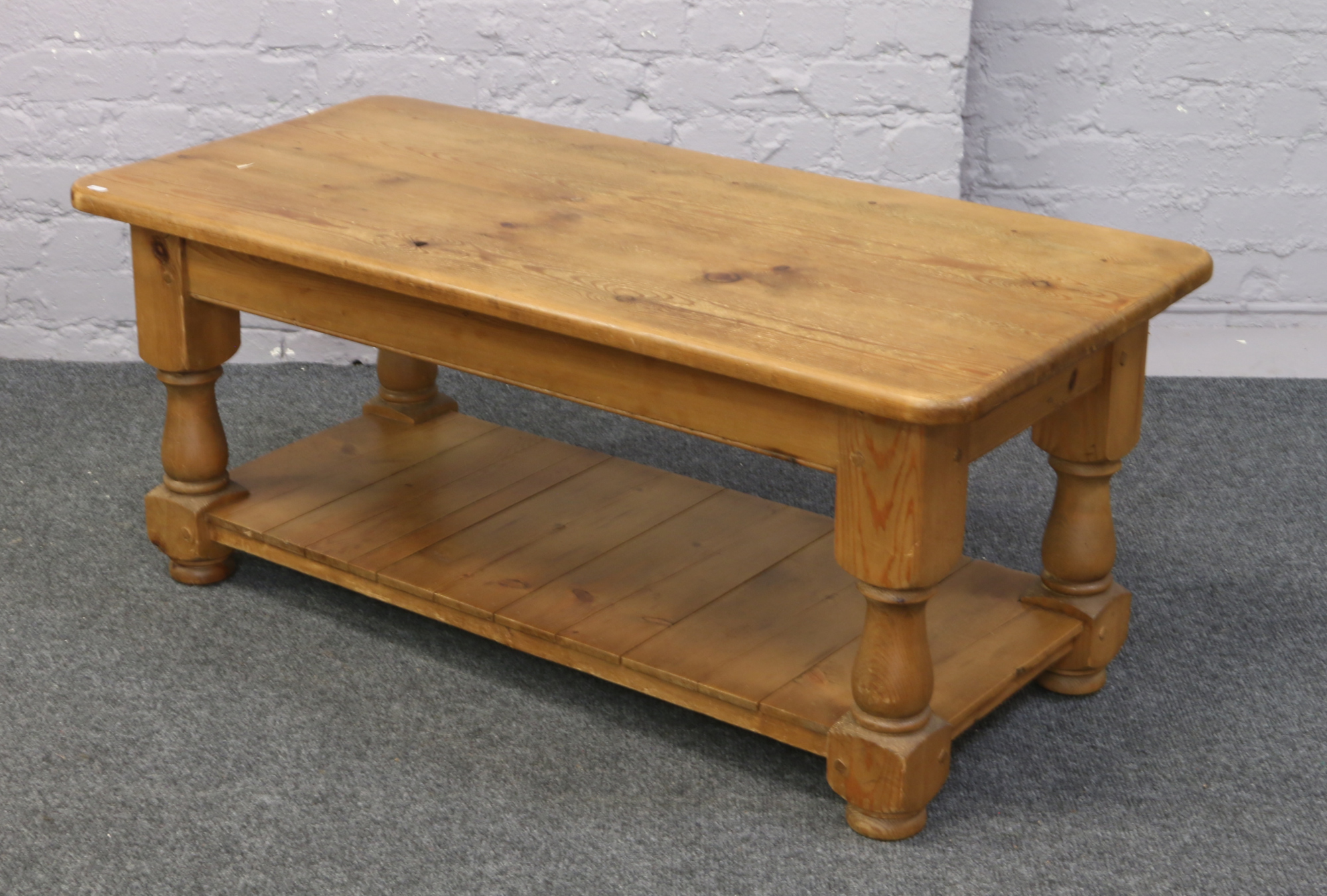 A pine two tier coffee table.