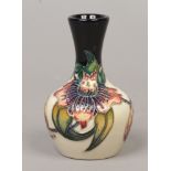 A small Moorcroft bud vase decorated in the Anna Lily design, 10cm.