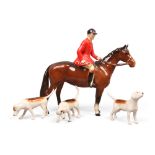 A Beswick model of a mounted huntsman along with three associated hounds.