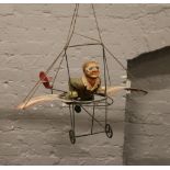 A metal and composite novelty model of a man riding a hang glider.