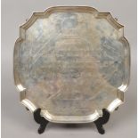 A presentation silver salver raised on four ball and claw feet for Mr Edward Stansfeld for