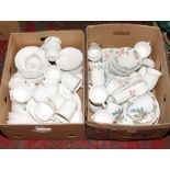 Two boxes of Wedgwood dinnewares in the Passionbird and Strawberry and Vine patterns.