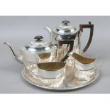 A silver plate four part tea service on tray.