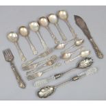 A small box of silver plated flatwares including a pair of glass handled salad servers.