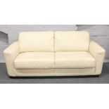 A cream leather three seat sofa bed.