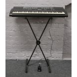 A Yamaha PSR- 200 keyboard on stand with power supply.