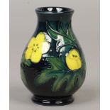 A Moorcroft small baluster shaped vase by Sally Tuffin, decorated in the Buttercup pattern, first