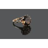 A 9ct gold cocktail ring set with a smokey quartz stone, size O.