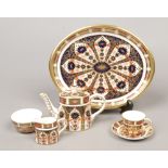 A Royal Crown Derby 1128 Imari pattern miniature tea set, consisting of teapot, sugar bowl, milk