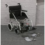 A Days folding wheel chair with spare set of foot rests.