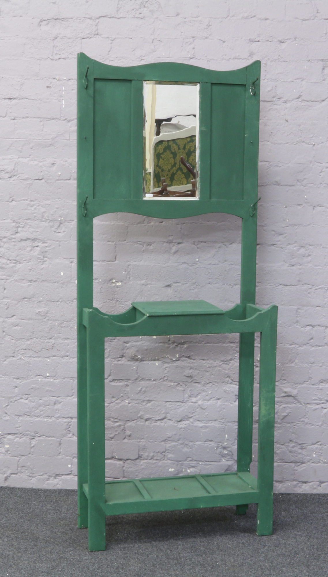 A painted green wooden hall stand with bevel edge mirror back 183cm x 72cm x 29cm.