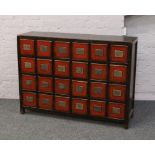 A Chinese hardwood chest of 24 drawers with distressed decoration and flush drawer pulls, 90cm x