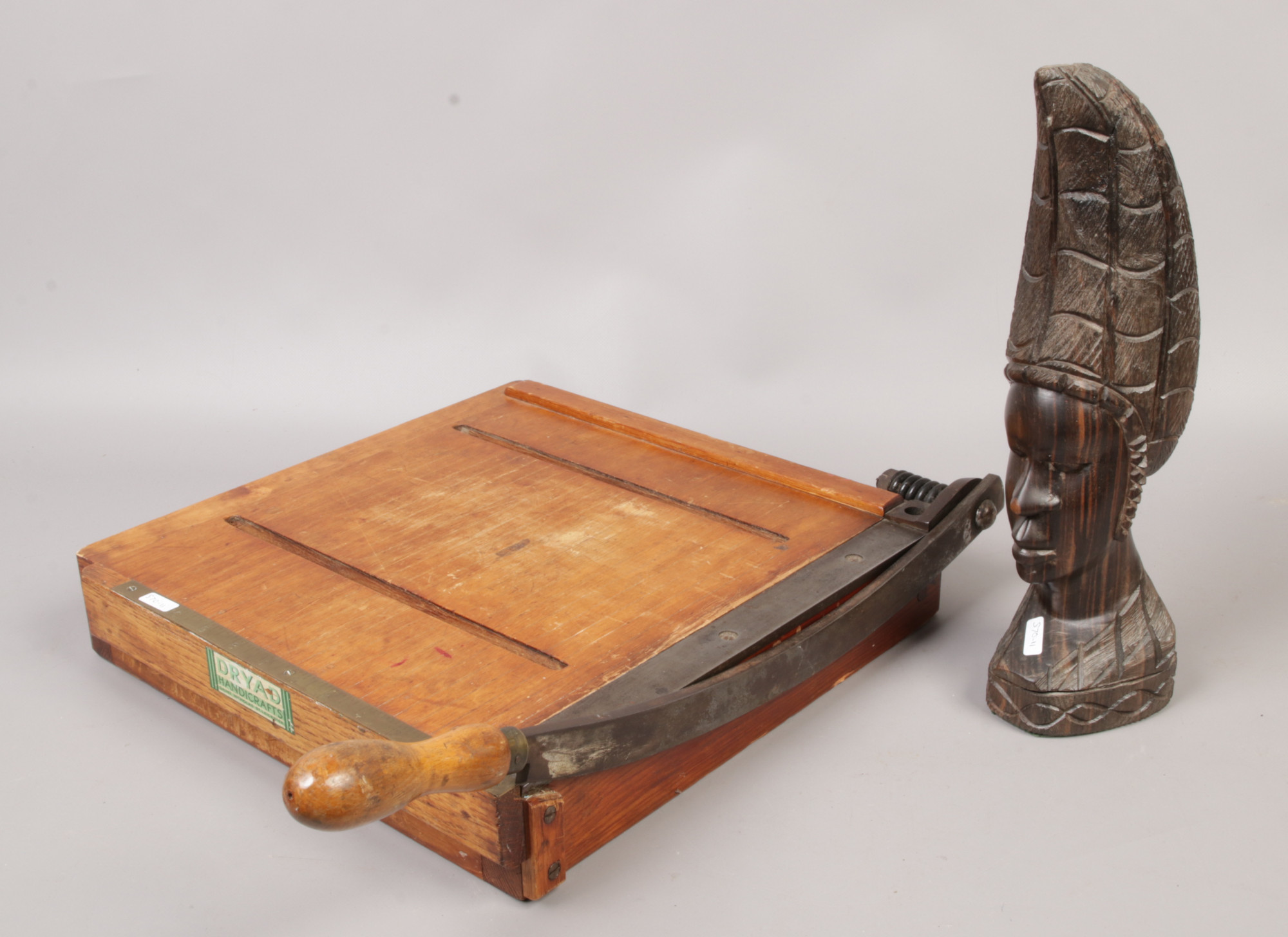 A vintage paper guillotine by Dryad Handicrafts of Leicester and a tribal carved hardwood bust.