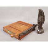 A vintage paper guillotine by Dryad Handicrafts of Leicester and a tribal carved hardwood bust.