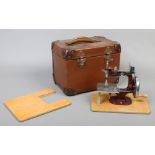 A cased vintage Essex miniature hand operated child's sewing machine.